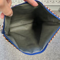 Load image into Gallery viewer, Water resistant interior of patchwork clutch purse.
