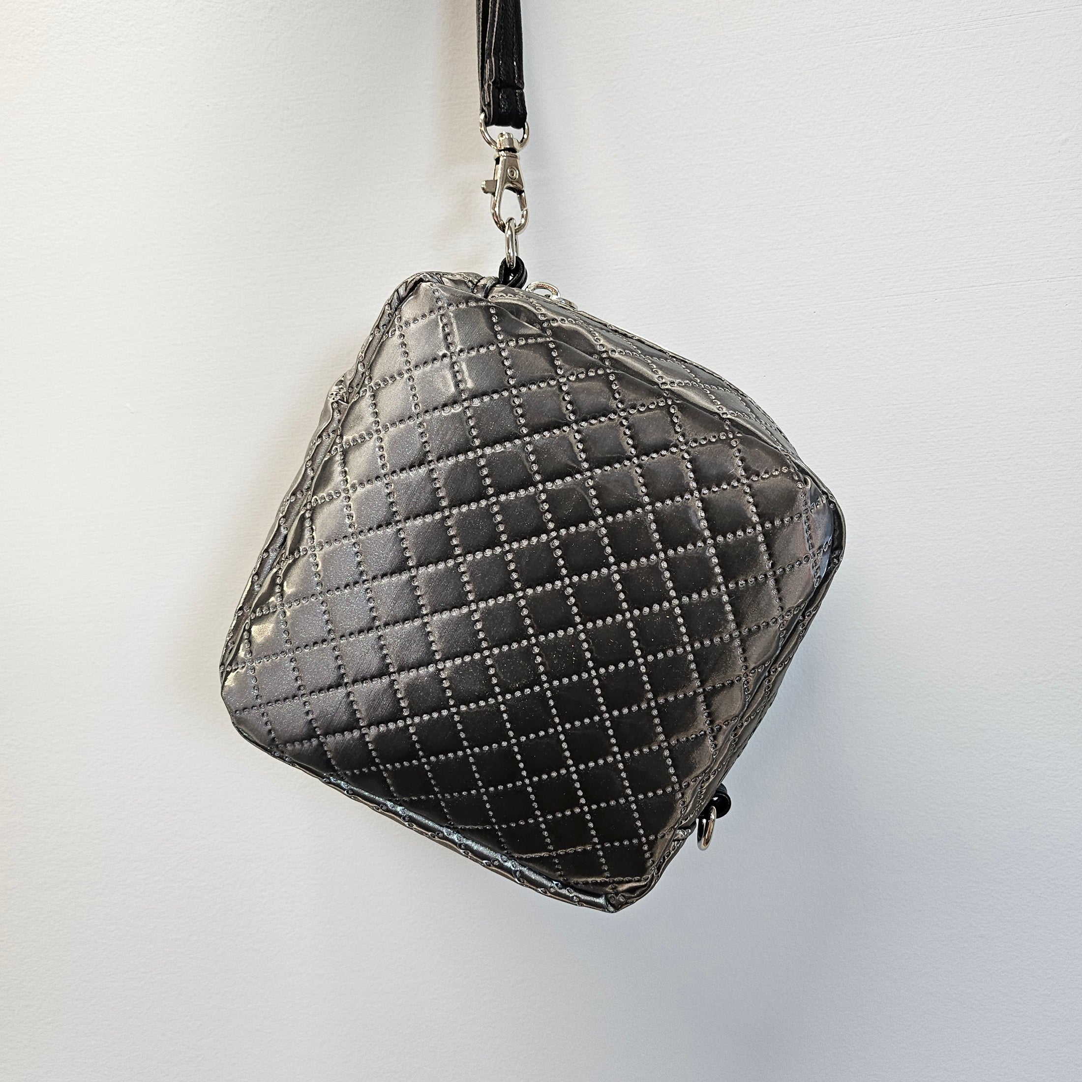 Quilted gray handbag on a light gray background