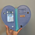 Load image into Gallery viewer, Open purple wallet with card slots and a visible brand label, held by a hand against a neutral background.
