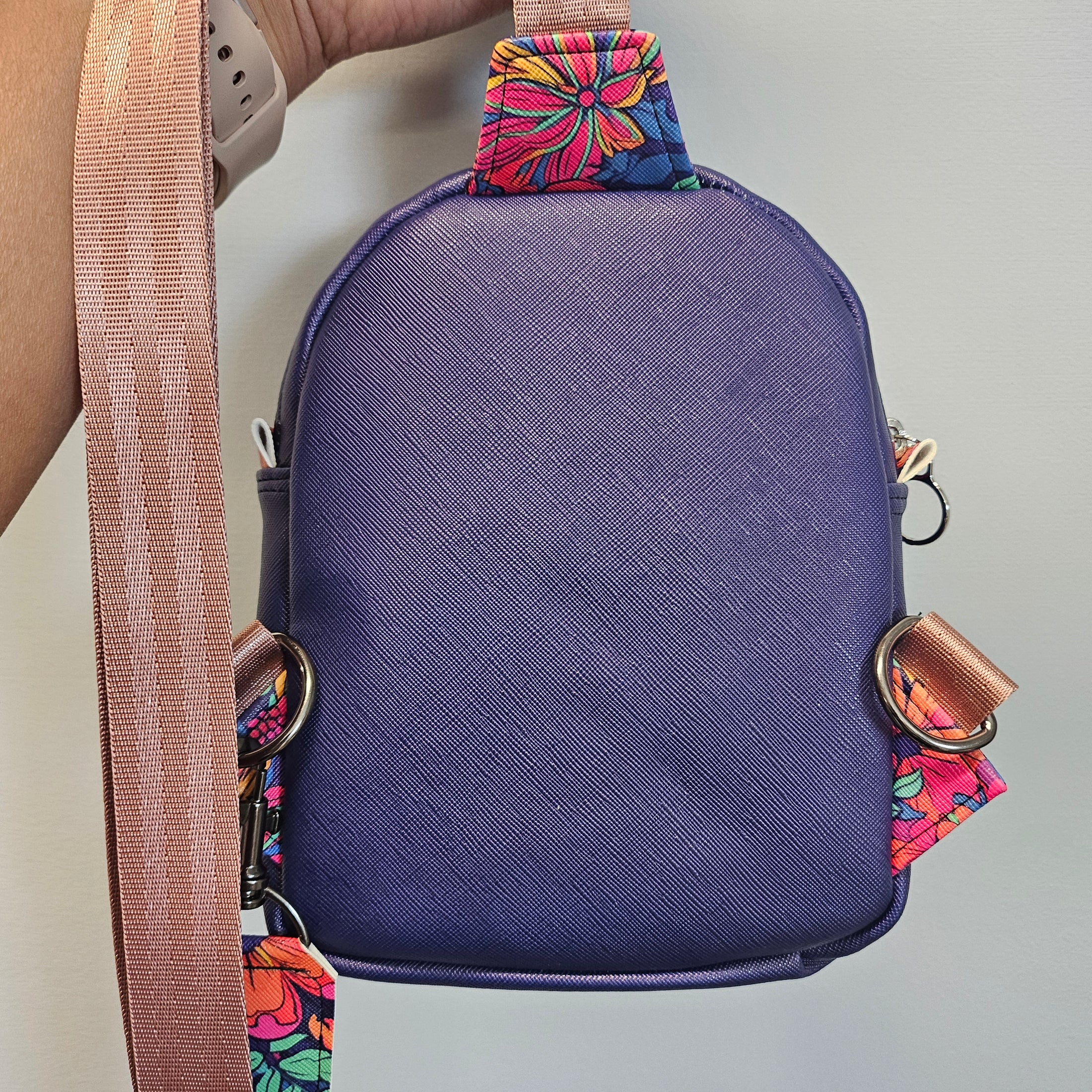 Blue bag with a colorful strap on a gray background