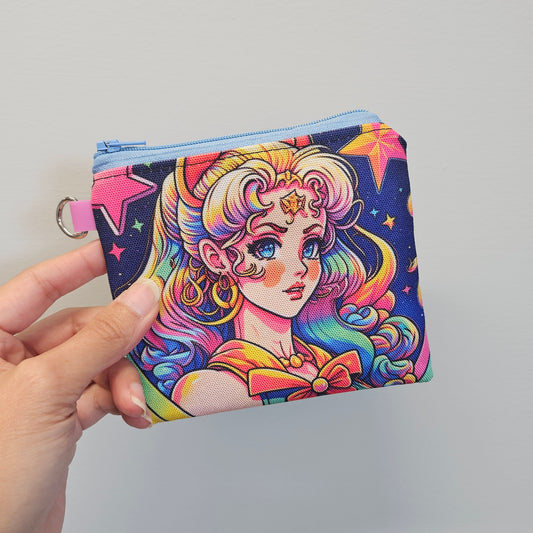 Colorful wallet with a cartoon design held by a hand against a gray background