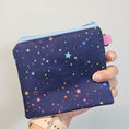 Load image into Gallery viewer, Small pouch with star pattern held by a hand against a neutral background
