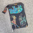 Load image into Gallery viewer, Colorful animal design on a black pouch against a gray background
