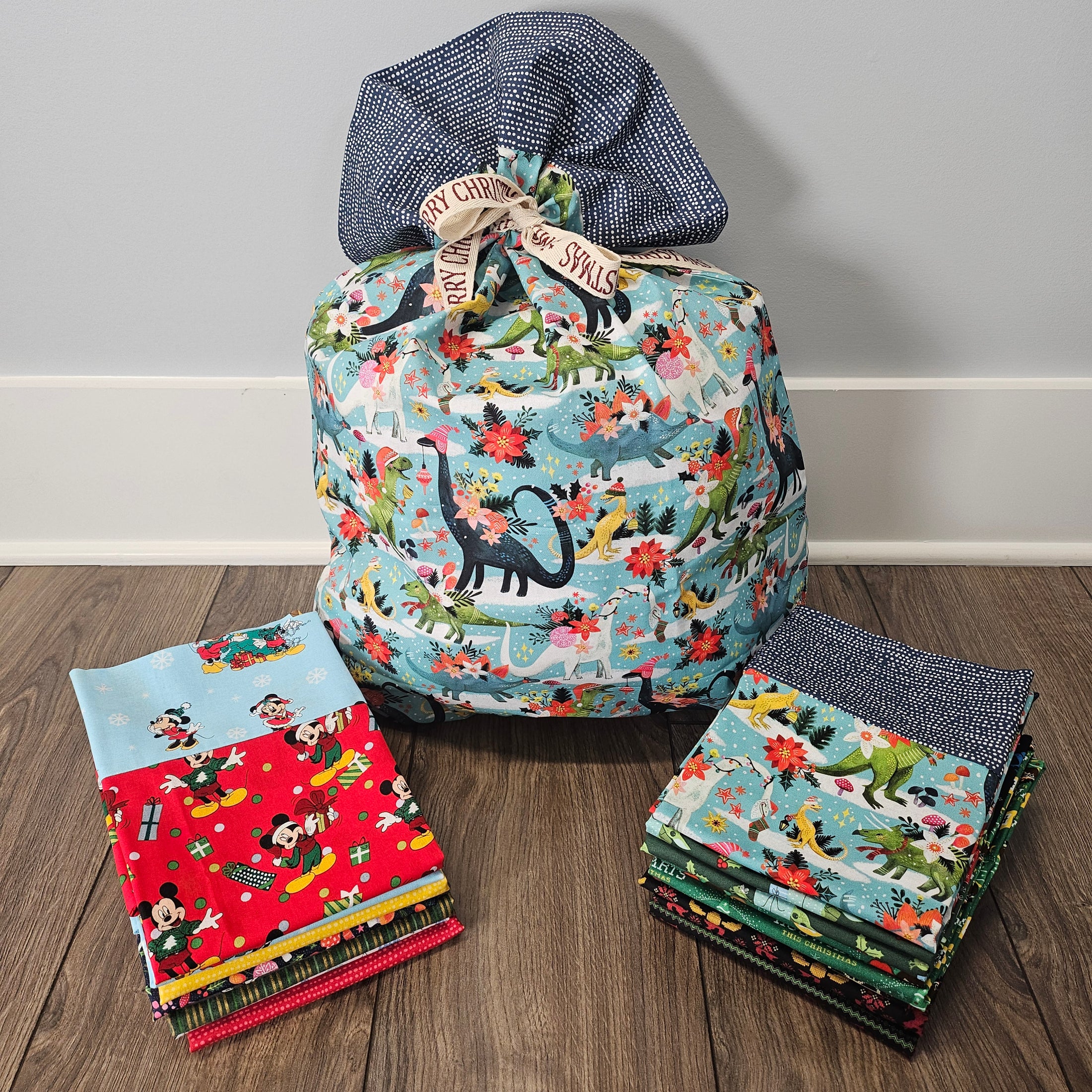 Christmas pillowcases that can be used as gift bags sitting on the floor.