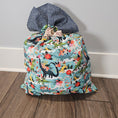 Load image into Gallery viewer, Floral and dinosaur-patterned holiday pillowcase.
