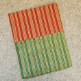 Load image into Gallery viewer, Striped red and green rug on a concrete floor
