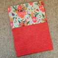 Load image into Gallery viewer, Red holiday pillowcase folded with a gray background.
