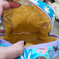 Load image into Gallery viewer, Close-up of a colorful bag with a yellow interior pattern, held by a hand.
