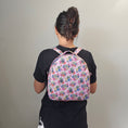 Load image into Gallery viewer, A person wearing the mandalorian inspired backpack on their back with straps over both shoulders.
