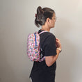 Load image into Gallery viewer, A person wearing the mandalorian backpack from the side view.
