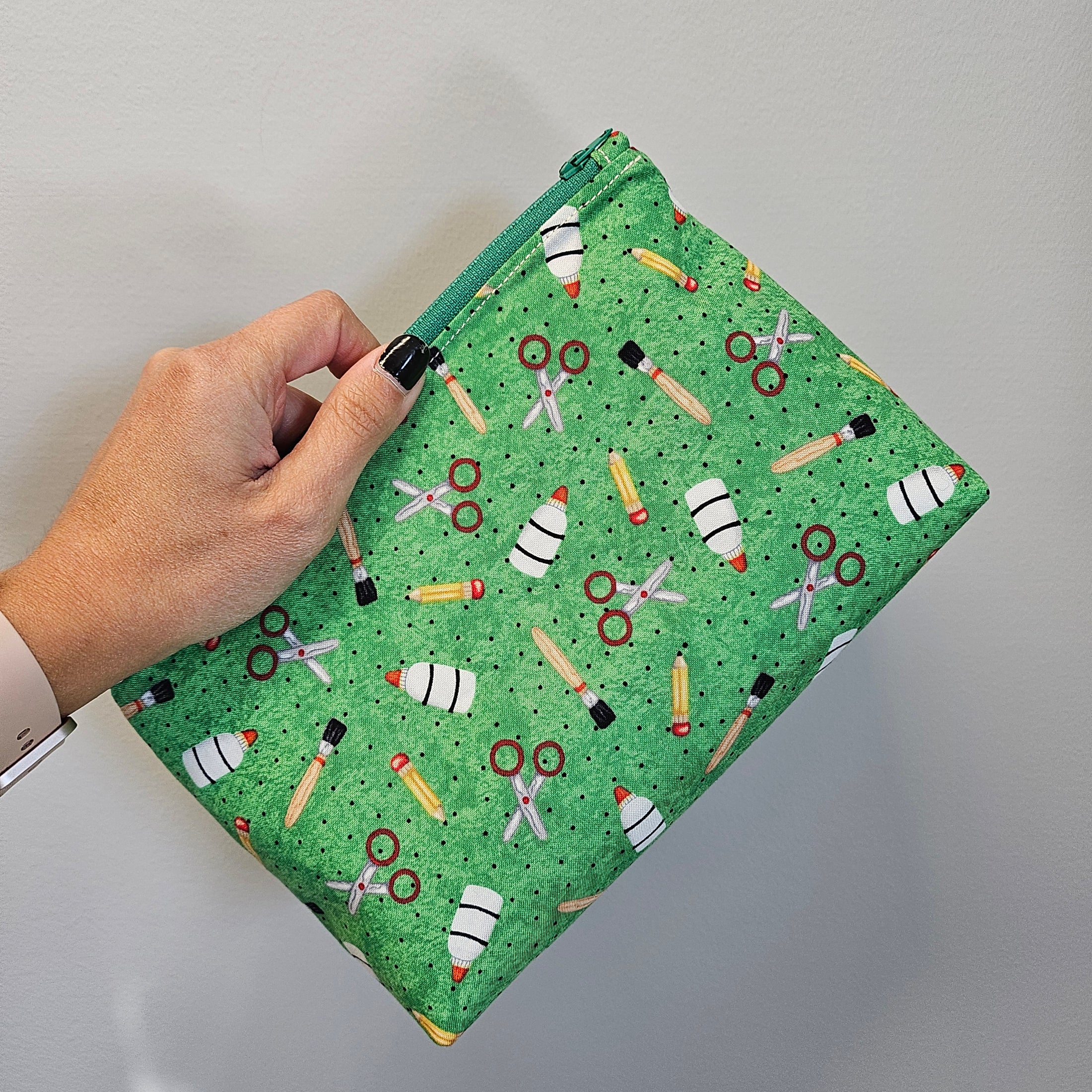 Green school supply zipper storage pouch.
