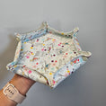 Load image into Gallery viewer, Hand holding a hexagon fabric tray in front of a gray wall.
