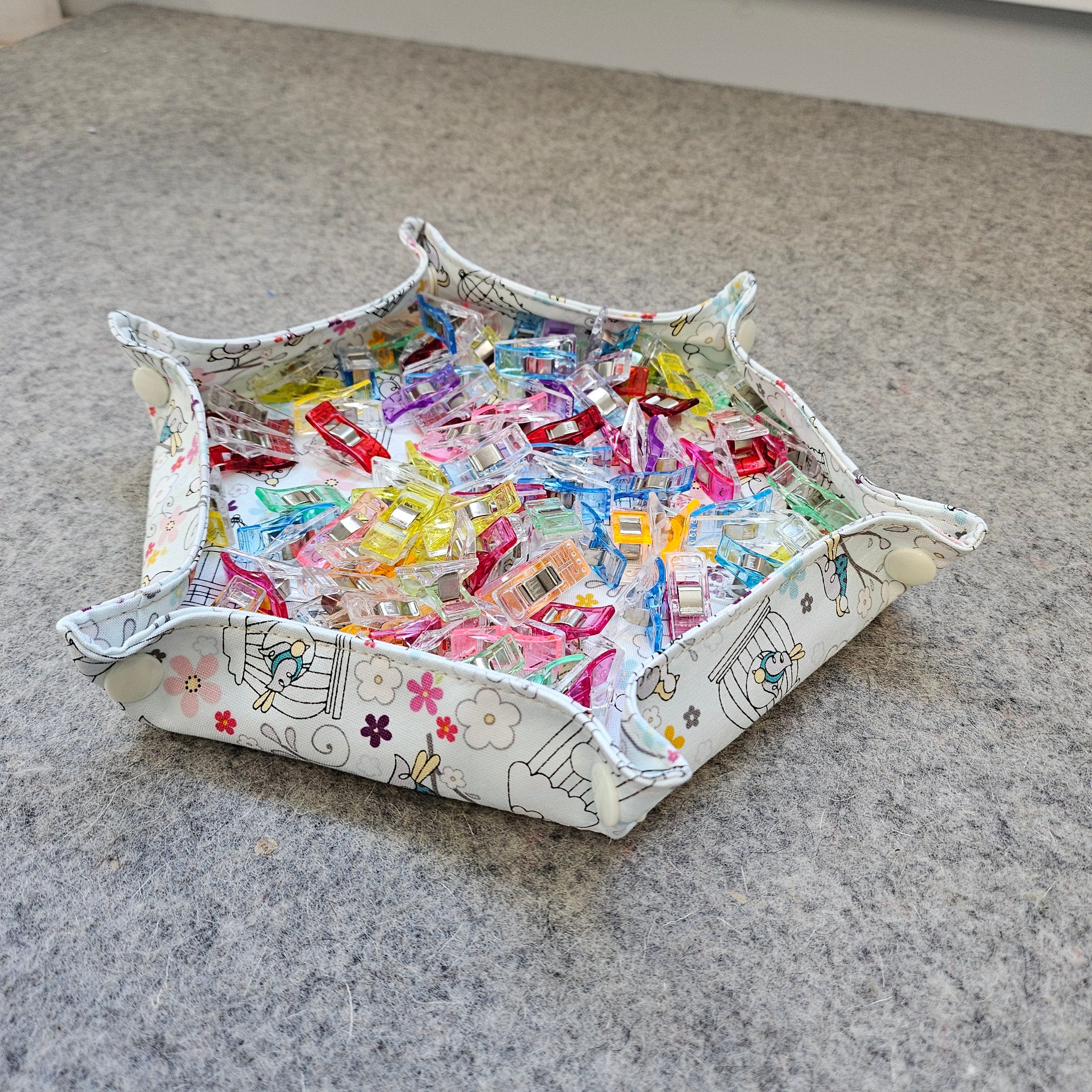 Crafting tray filled with sewing clips.