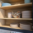 Load image into Gallery viewer, Stacked ceramic plates and bowls in a wooden cabinet.
