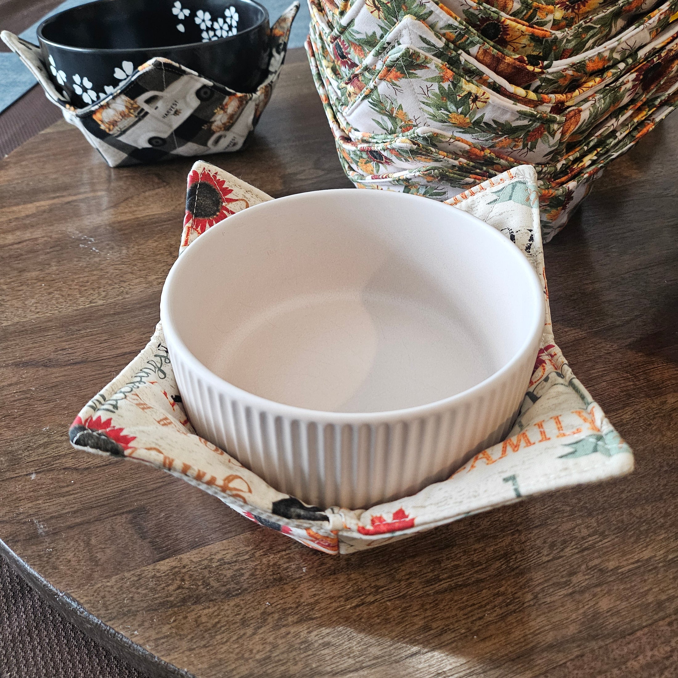White bowl on a floral-patterned fabric coaster on a wooden surface