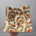 Load image into Gallery viewer, Fabric with autumnal pattern featuring pumpkins, sunflowers, and leaves held against a gray background
