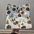 Load image into Gallery viewer, Bowl cozy with bear and tree pattern held by a hand against a gray background
