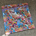 Load image into Gallery viewer, Colorful fabric with cartoon character pattern on a gray surface
