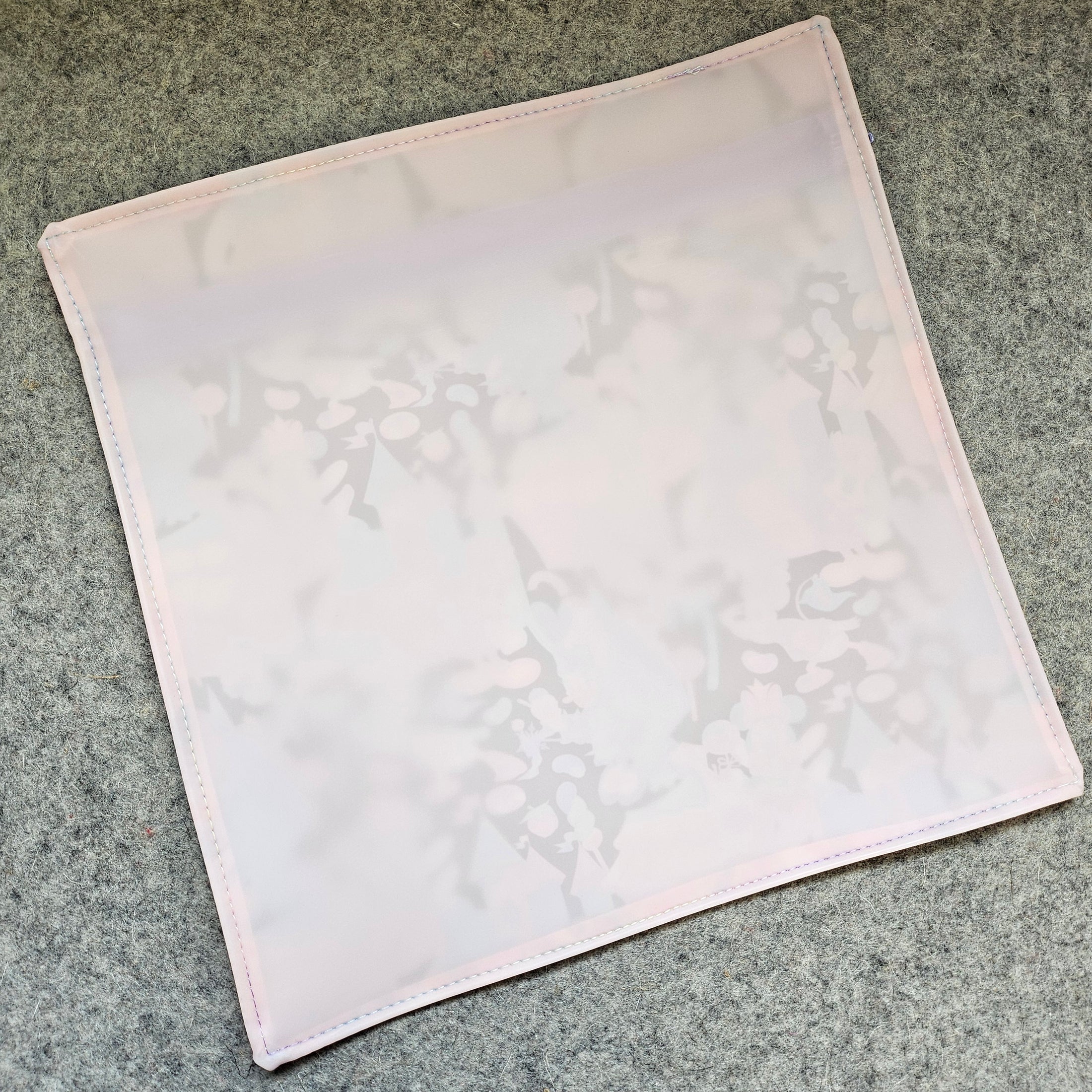 White fabric square on a gray textured surface