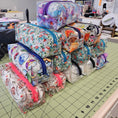 Load image into Gallery viewer, Colorful fabric bags with zippers on a cutting mat
