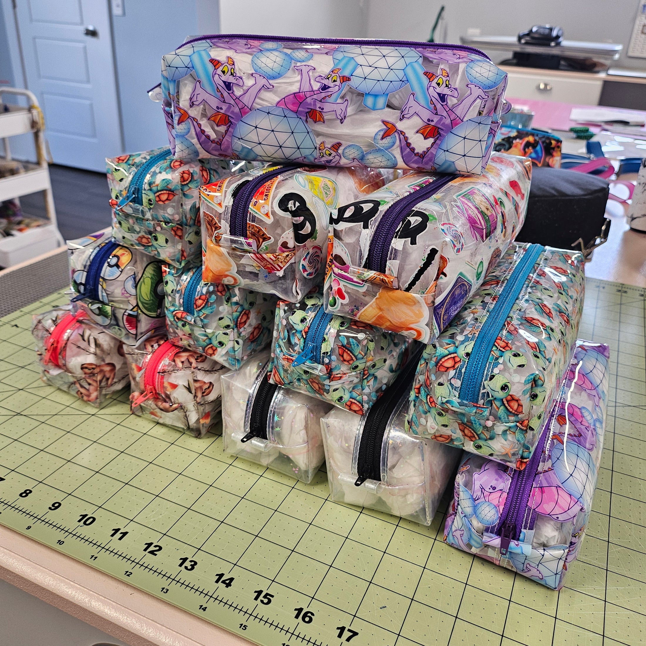 Stack of colorful fabric bags on a cutting mat with a ruler