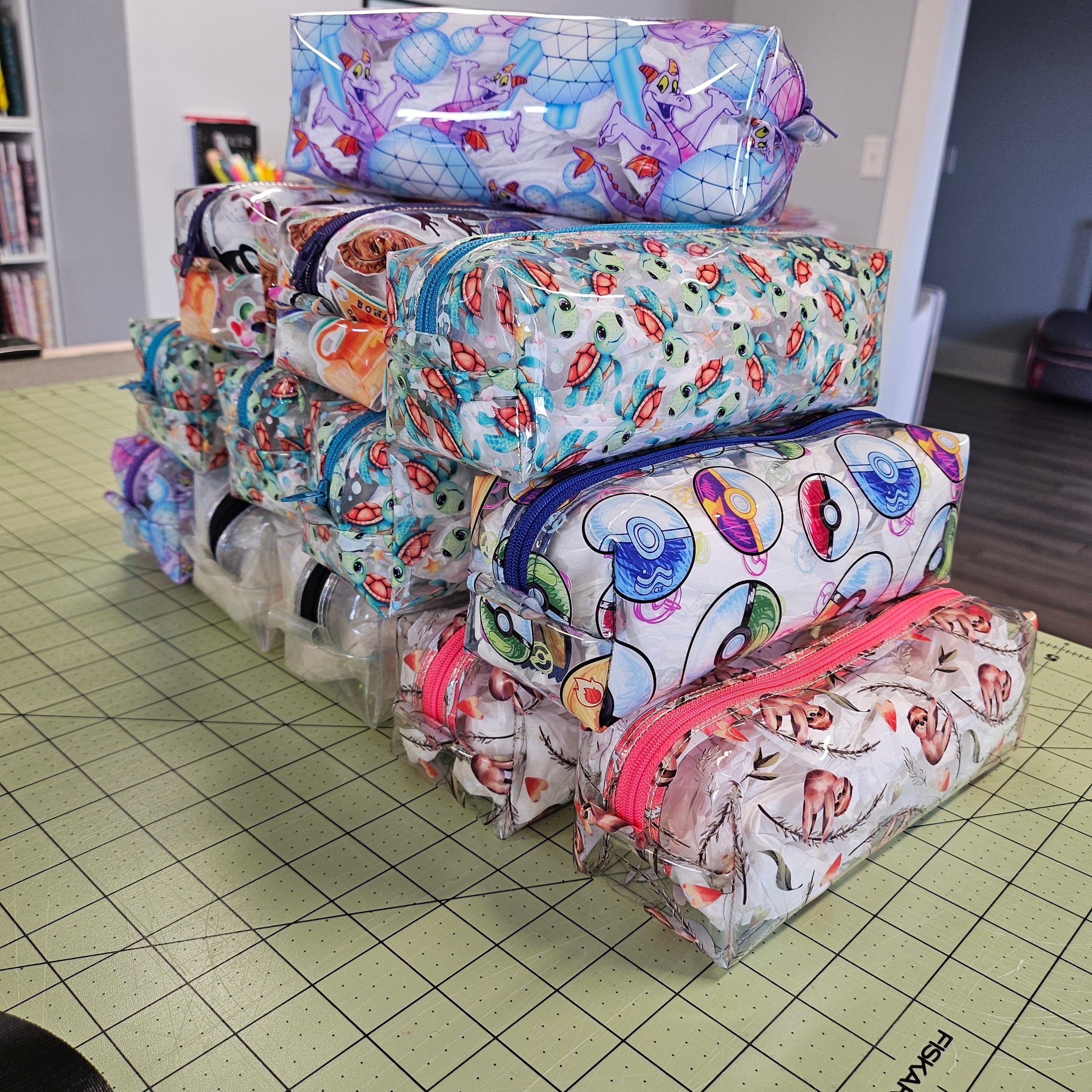 Stack of colorful fabric bags on a grid-patterned surface