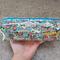 Load image into Gallery viewer, Pencil case with turtle pattern held by a hand on a neutral background
