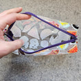 Load image into Gallery viewer, Clear pouch with ghost and candy design held by a hand on a gray surface
