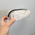 Load image into Gallery viewer, Hand holding a clear plastic bag with white cotton balls against a gray background
