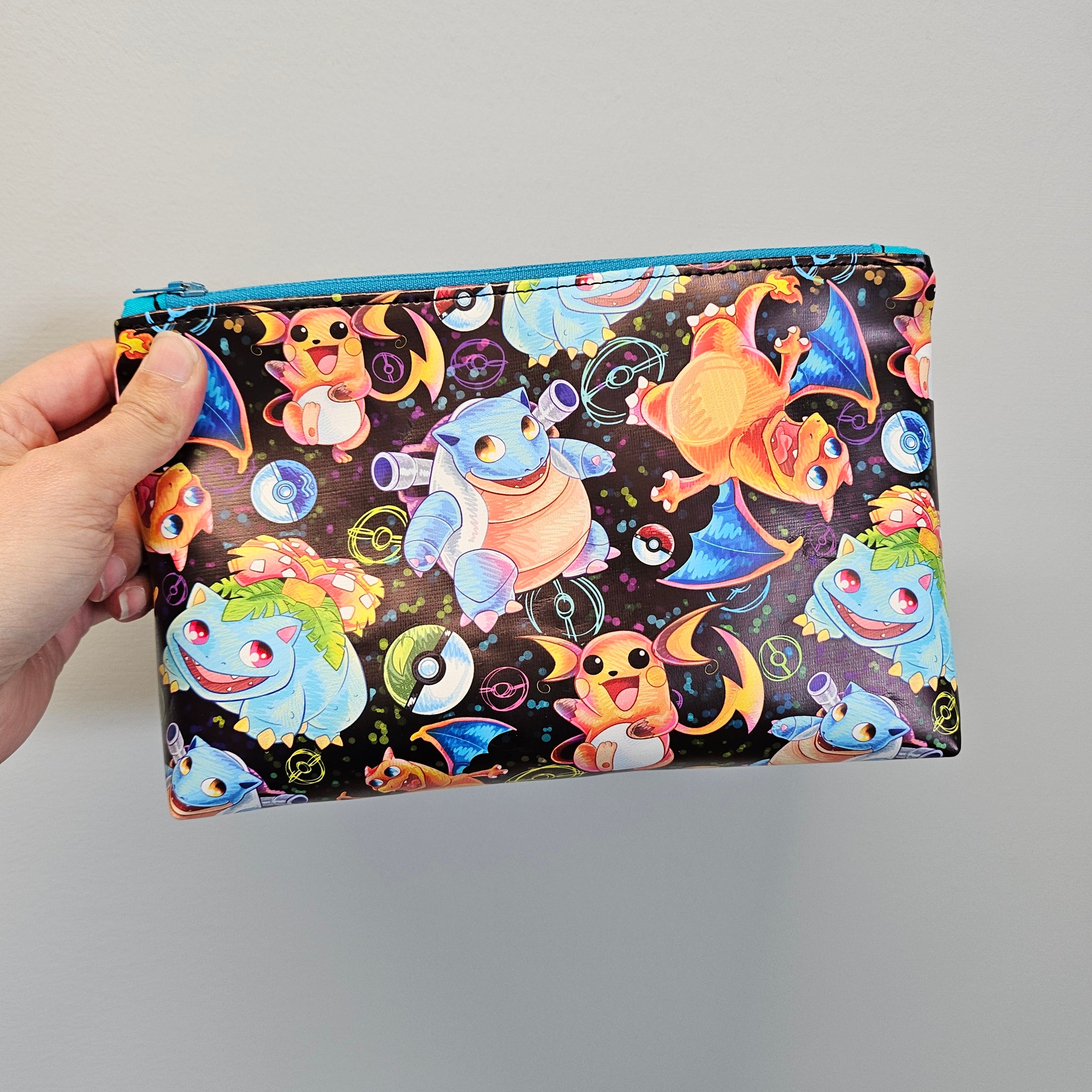 Pokemon vinyl zipper pouch held against a light gray background