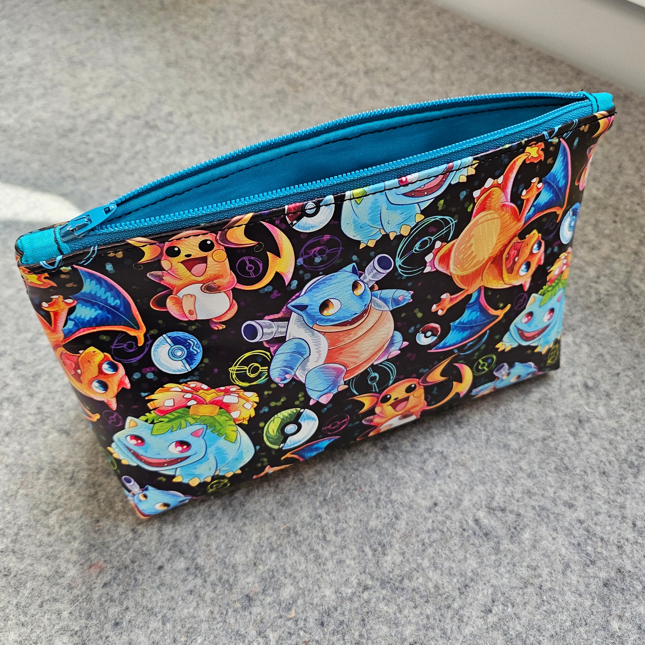 Colorful pouch with cartoon characters on a gray surface