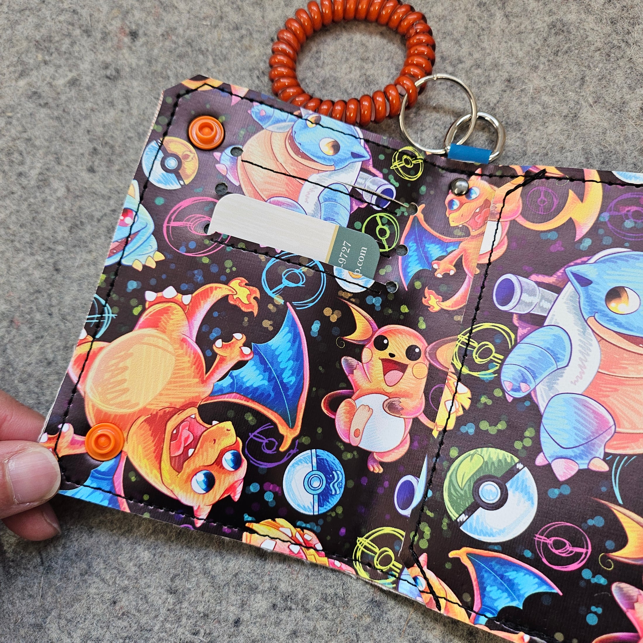 Colorful keychain with cartoon characters on a textured surface