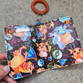 Load image into Gallery viewer, Colorful phone case with cartoon characters and Pokémon logos on a textured surface
