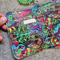 Load image into Gallery viewer, Colorful patterned wallet with keychain on a gray surface
