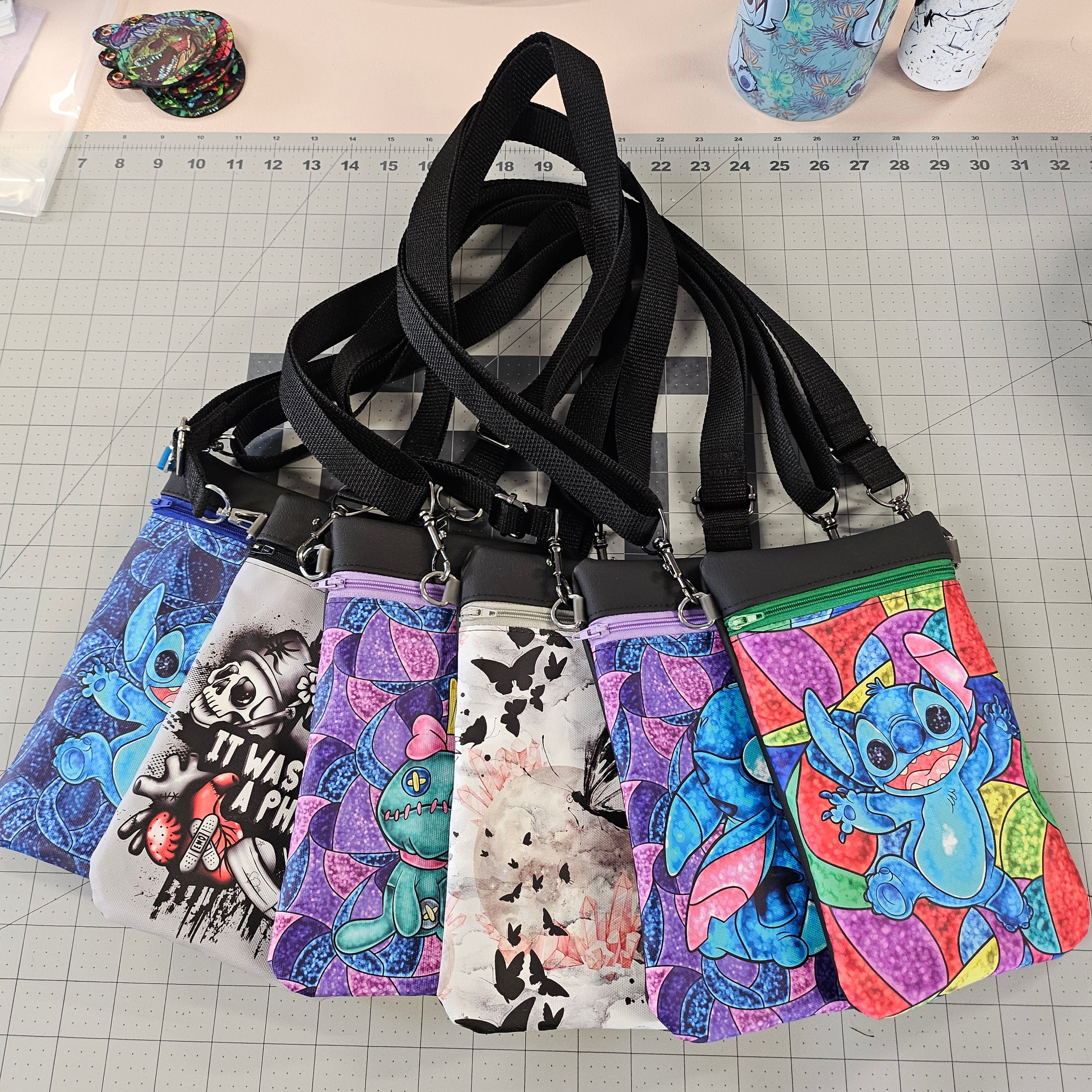 Colorful fabric bags with straps on a cutting mat