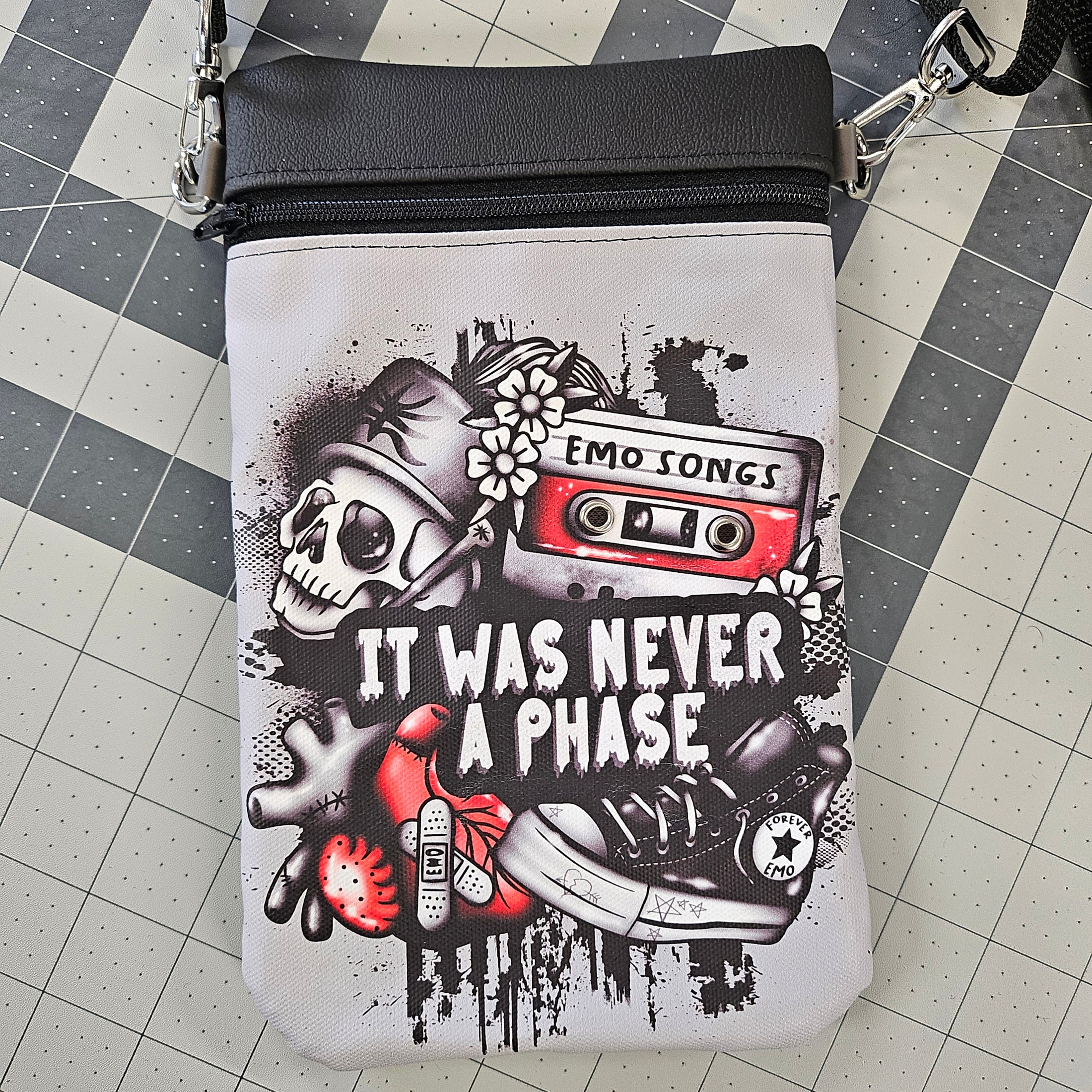 Pouch with graphic design featuring a skull, cassette tape, and sneakers on a grid background