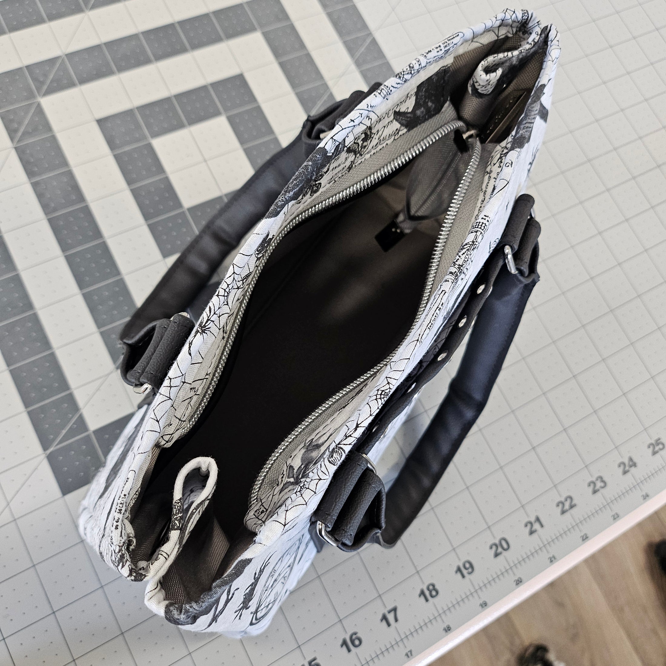 Black and white patterned pouch on a grid surface