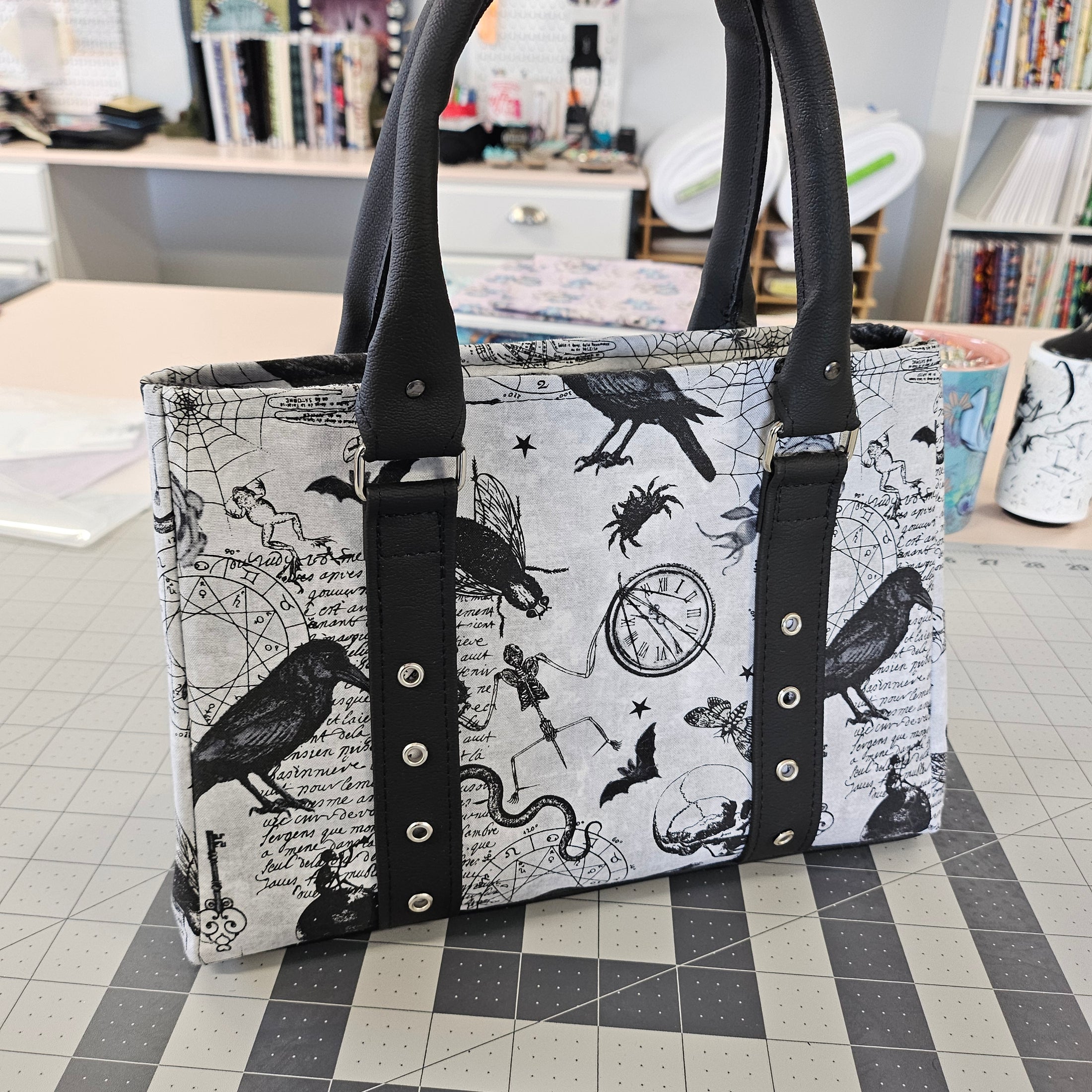Tote bag with black and white pattern on a checkered floor