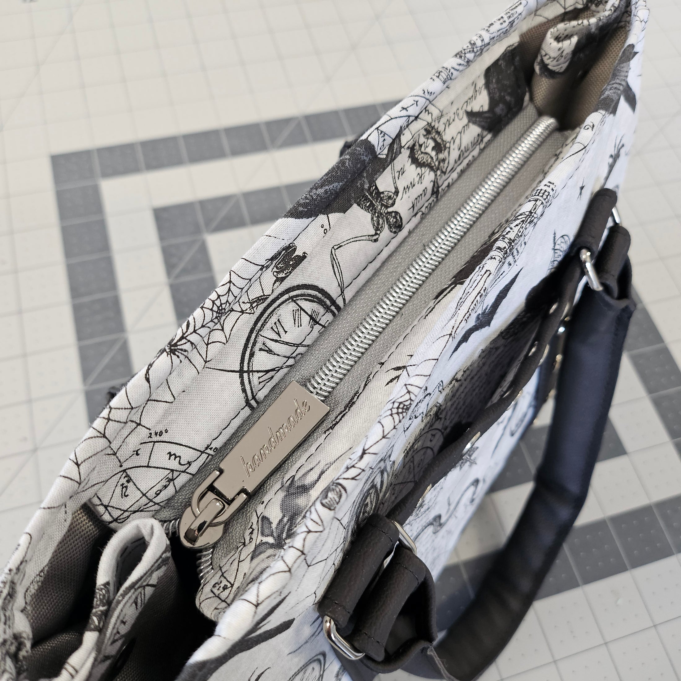 Patterned bag with a zipper on a tiled floor