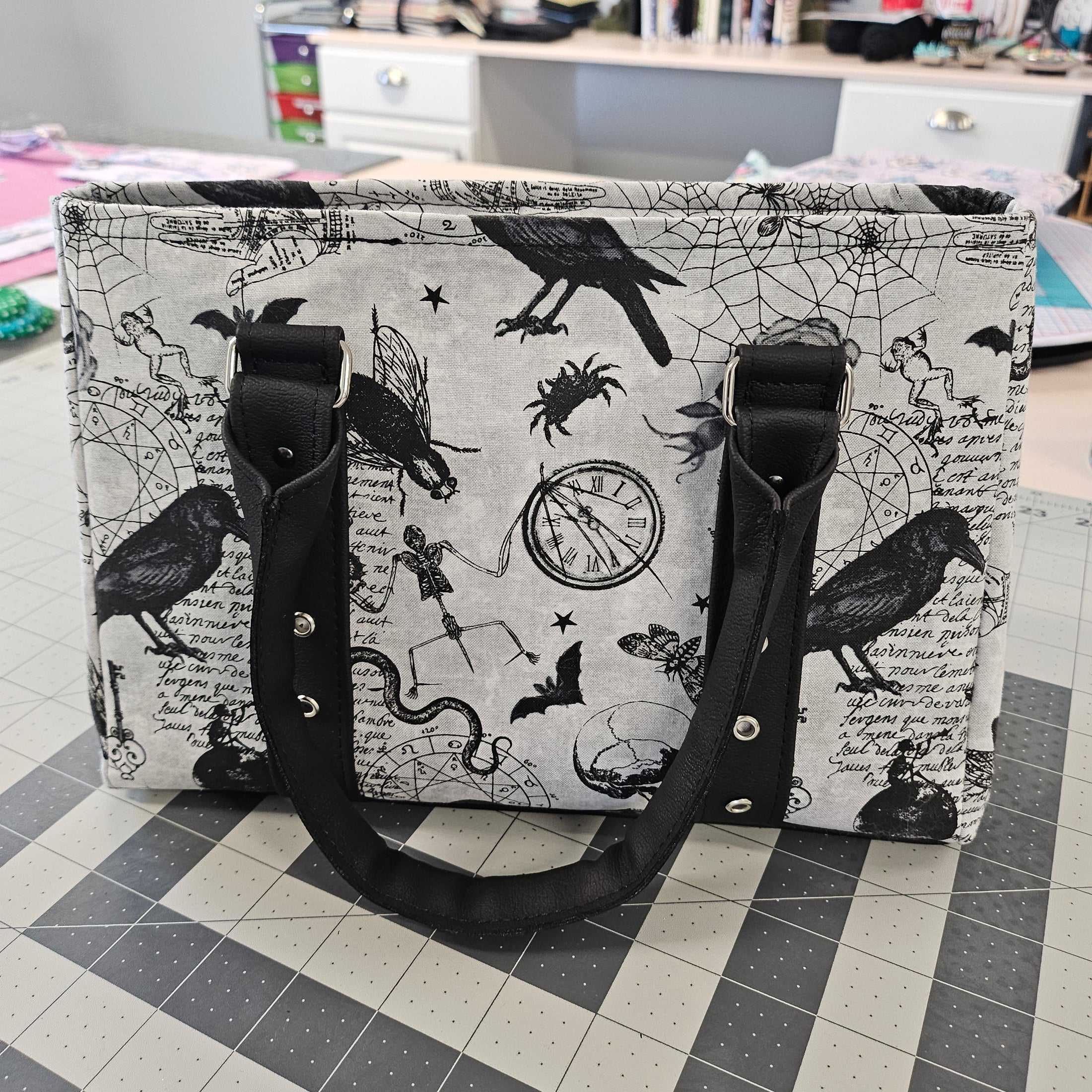 Handbag with black and white pattern on a checkered floor