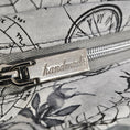 Load image into Gallery viewer, Close-up of a zipper with 'handmade' label on floral fabric background
