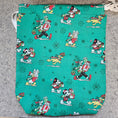 Load image into Gallery viewer, Teal fabric with cartoon character pattern on a gray surface
