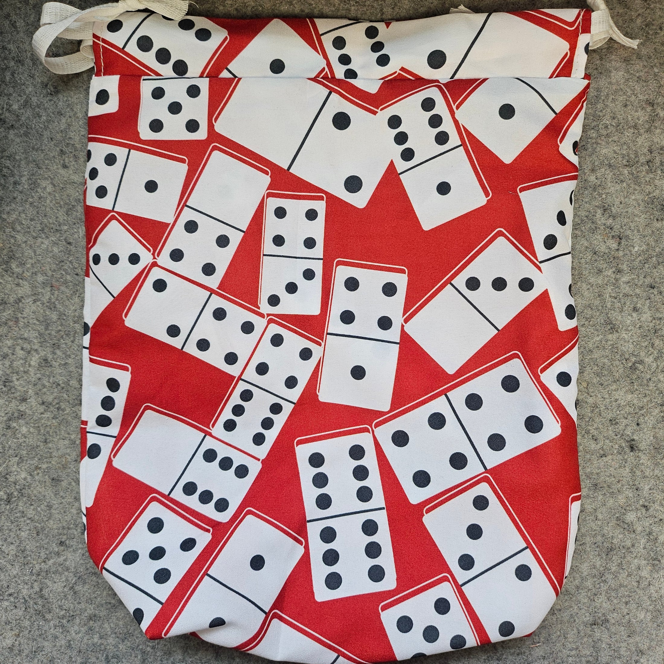 Red bag with large dominoes storage bag.