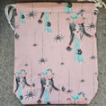 Load image into Gallery viewer, Pink bag with black spider design on a gray surface
