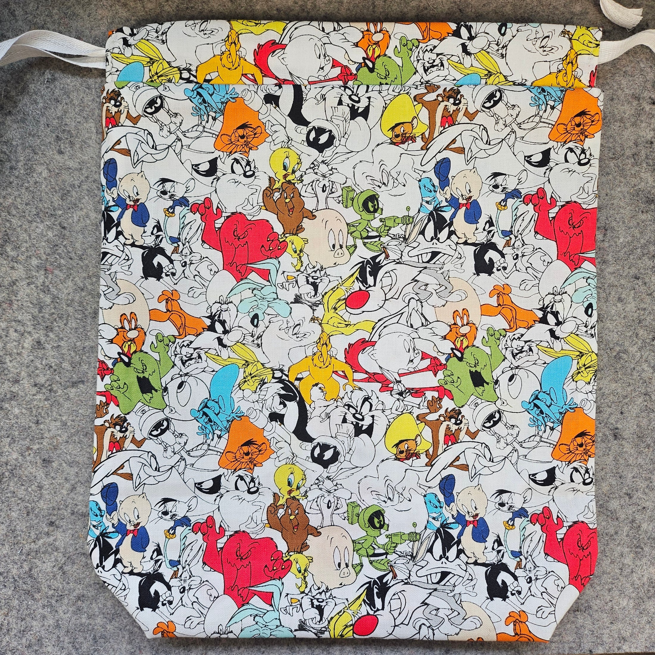 Patterned bag with cartoon character design on a gray surface