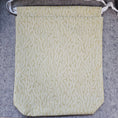 Load image into Gallery viewer, Fabric with a leaf pattern on a gray surface
