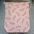 Load image into Gallery viewer, Pink drawstring bag with branch pattern on a gray surface
