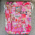 Load image into Gallery viewer, Pink-themed tote bag with various patterns and text on a gray surface
