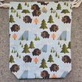 Load image into Gallery viewer, Patterned fabric with bears and trees on a textured surface
