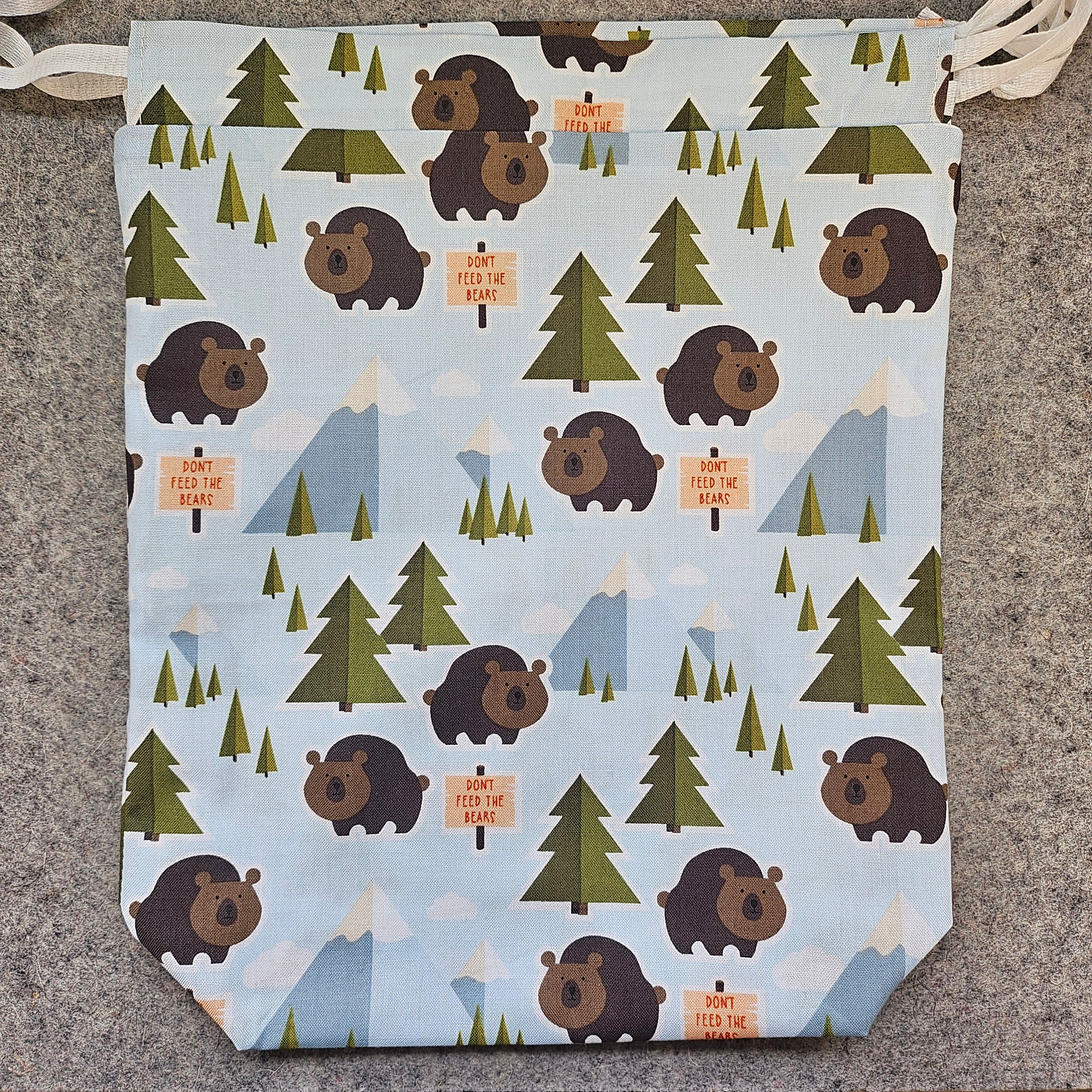 Patterned fabric with bears and trees on a textured surface